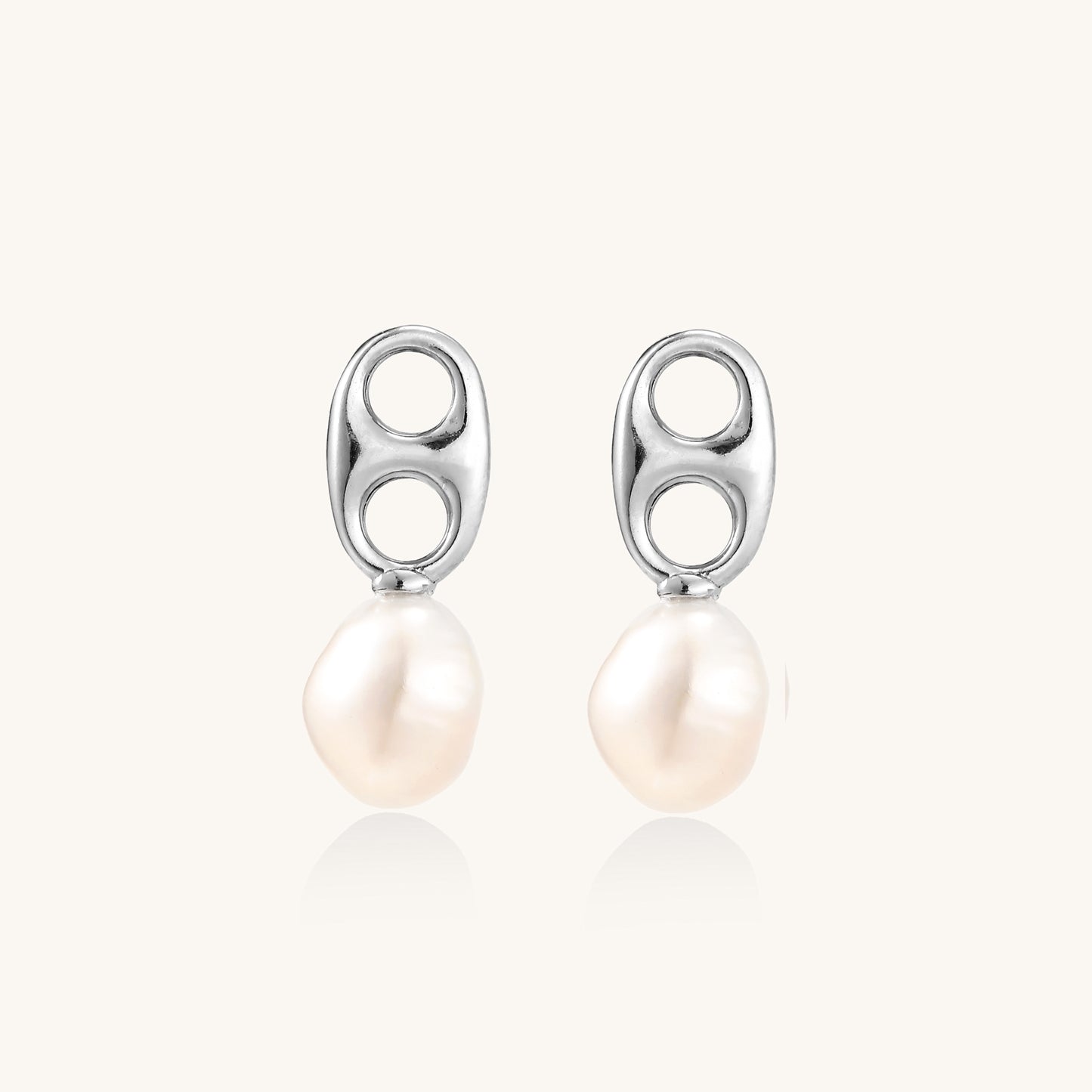 Sterling silver oval stud earrings with dual circular cutouts and suspended freshwater pearls on white background.