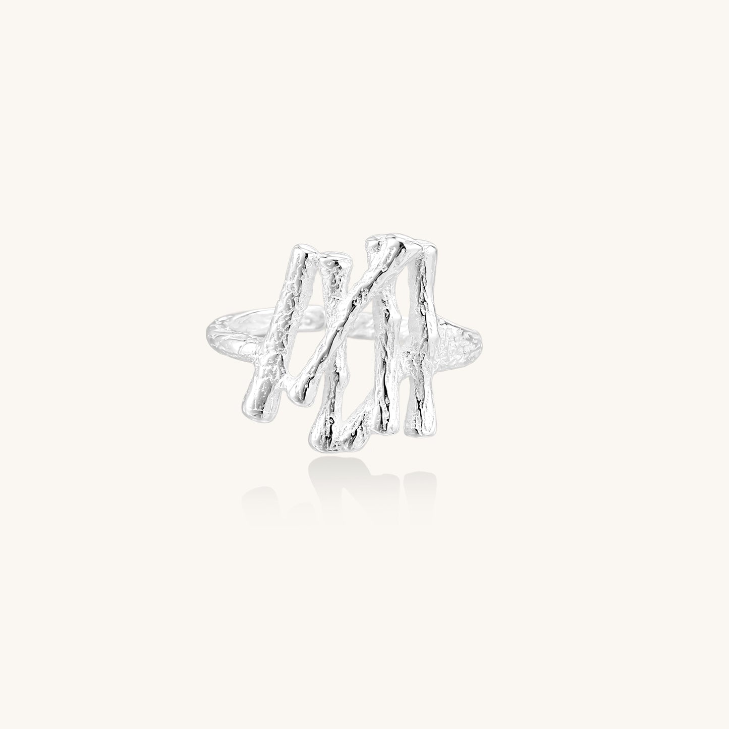 Chunky sterling silver ring with organic sculptural design and flowing abstract forms on white background