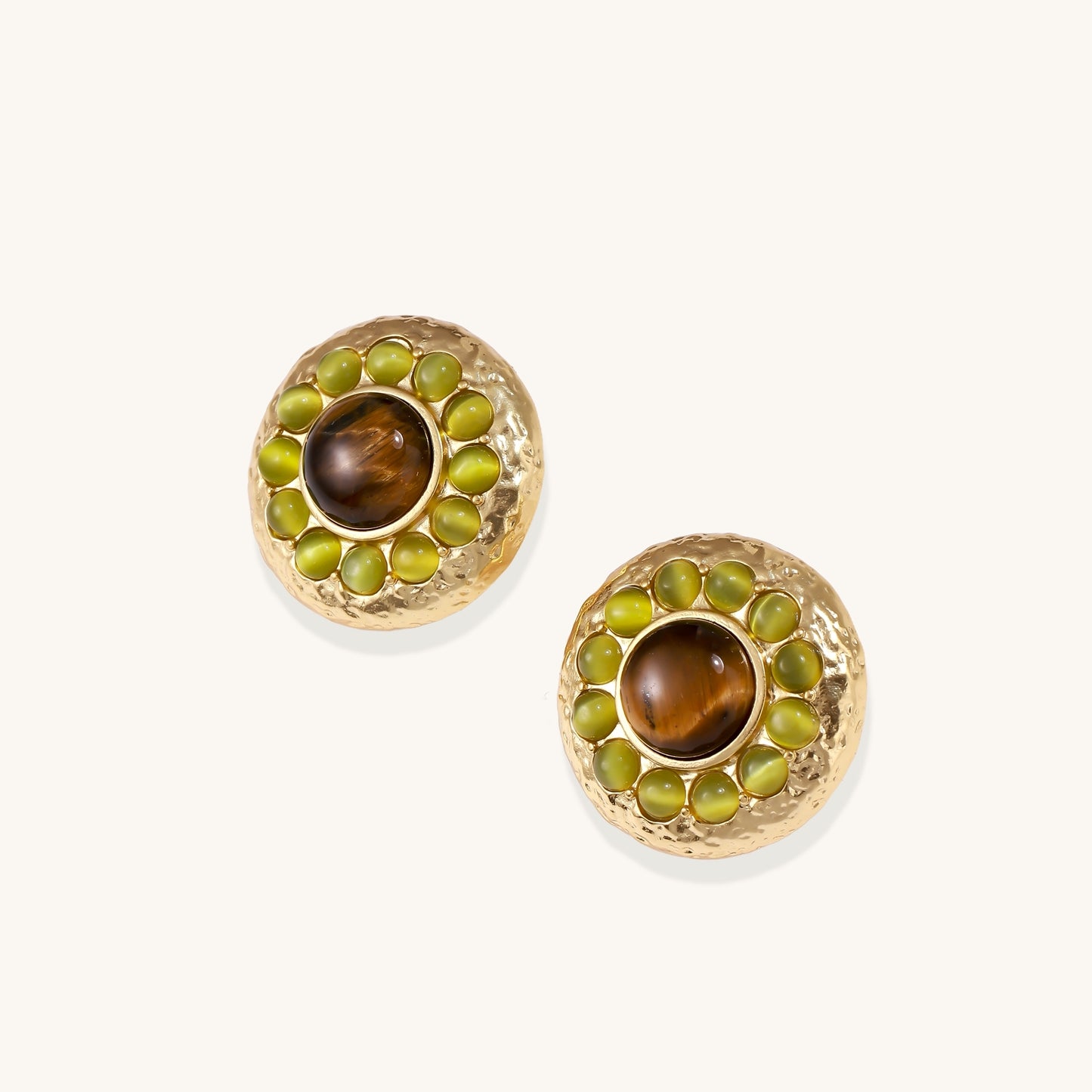 Gold-plated circular earrings featuring central tiger's eye stones surrounded by green liuli beads on textured metal base