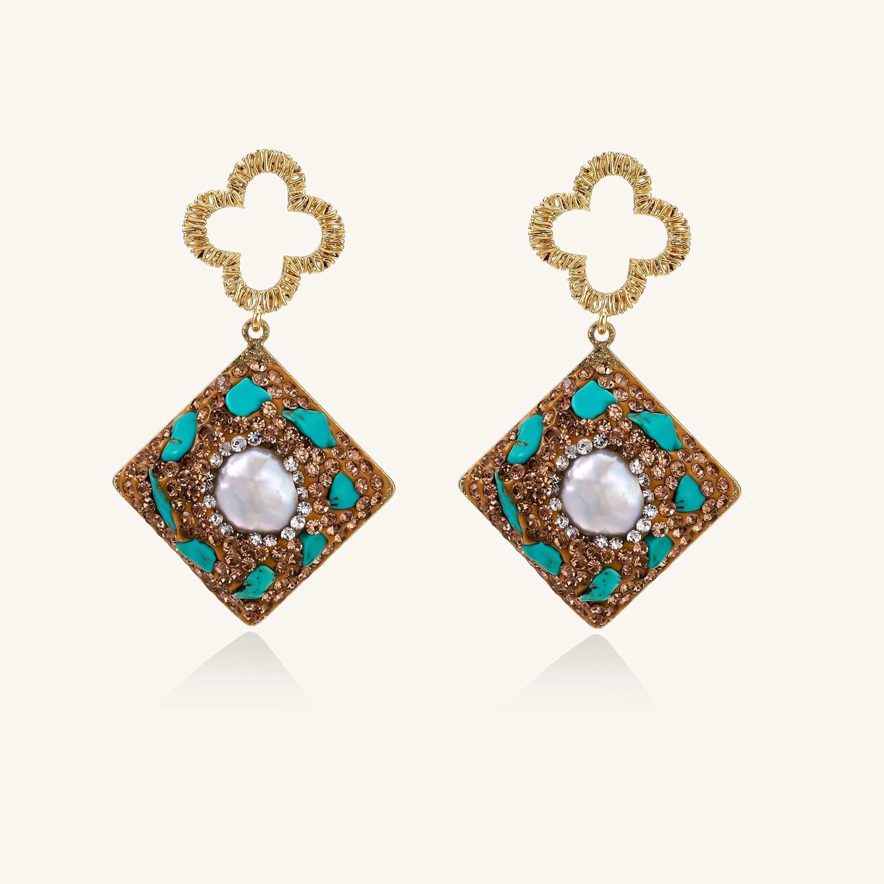 Gold quatrefoil stud earrings with ornate square pendants featuring turquoise stones and freshwater pearls