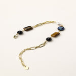 Gold-plated chain bracelet featuring tiger's eye, obsidian, freshwater pearls and abalone shell on white background