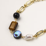 Gold-plated chain bracelet featuring tiger's eye, obsidian, freshwater pearls and abalone shell on white background