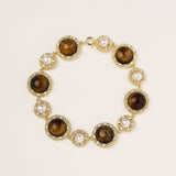 Ornate gold-plated bracelet with alternating brown tiger's eye stones and white freshwater pearls in crystal-accented settings