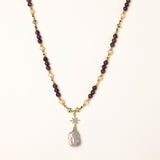 Gold-plated necklace with purple amethyst beads, pink pearls, and iridescent baroque pearl pendant beneath crystal star charm