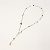 Long gold-plated necklace with alternating white and gray freshwater pearls spaced along delicate chain segments