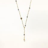 Long gold-plated necklace with alternating white and gray freshwater pearls spaced along delicate chain segments