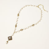 Elegant 14K gold plated necklace with freshwater pearls and ornate crystal diamond pendant on cream background.