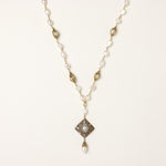 Elegant 14K gold plated necklace with freshwater pearls and ornate crystal diamond pendant on cream background.