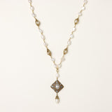 Elegant 14K gold plated necklace with freshwater pearls and ornate crystal diamond pendant on cream background.