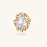Ornate gold-plated ring with large baroque pearl in decorative vine-like setting with small crystal accents