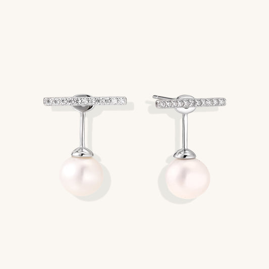 Sterling silver bar stud earrings with freshwater pearl drops on white background, minimalist jewelry design