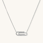 Delicate 14K gold plated chain necklace with crystal-accented carabiner-style pendant on white background