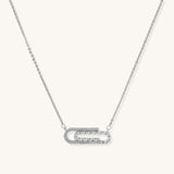 Delicate 14K gold plated chain necklace with crystal-accented carabiner-style pendant on white background
