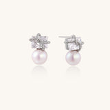 Gold-plated stud earrings with square crystal tops wrapped in twisted wire and freshwater pearl drops on white background