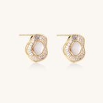 Gold-plated stud earrings with central freshwater pearl surrounded by baguette crystals in radial pattern