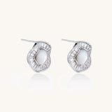 Gold-plated stud earrings with central freshwater pearl surrounded by baguette crystals in radial pattern