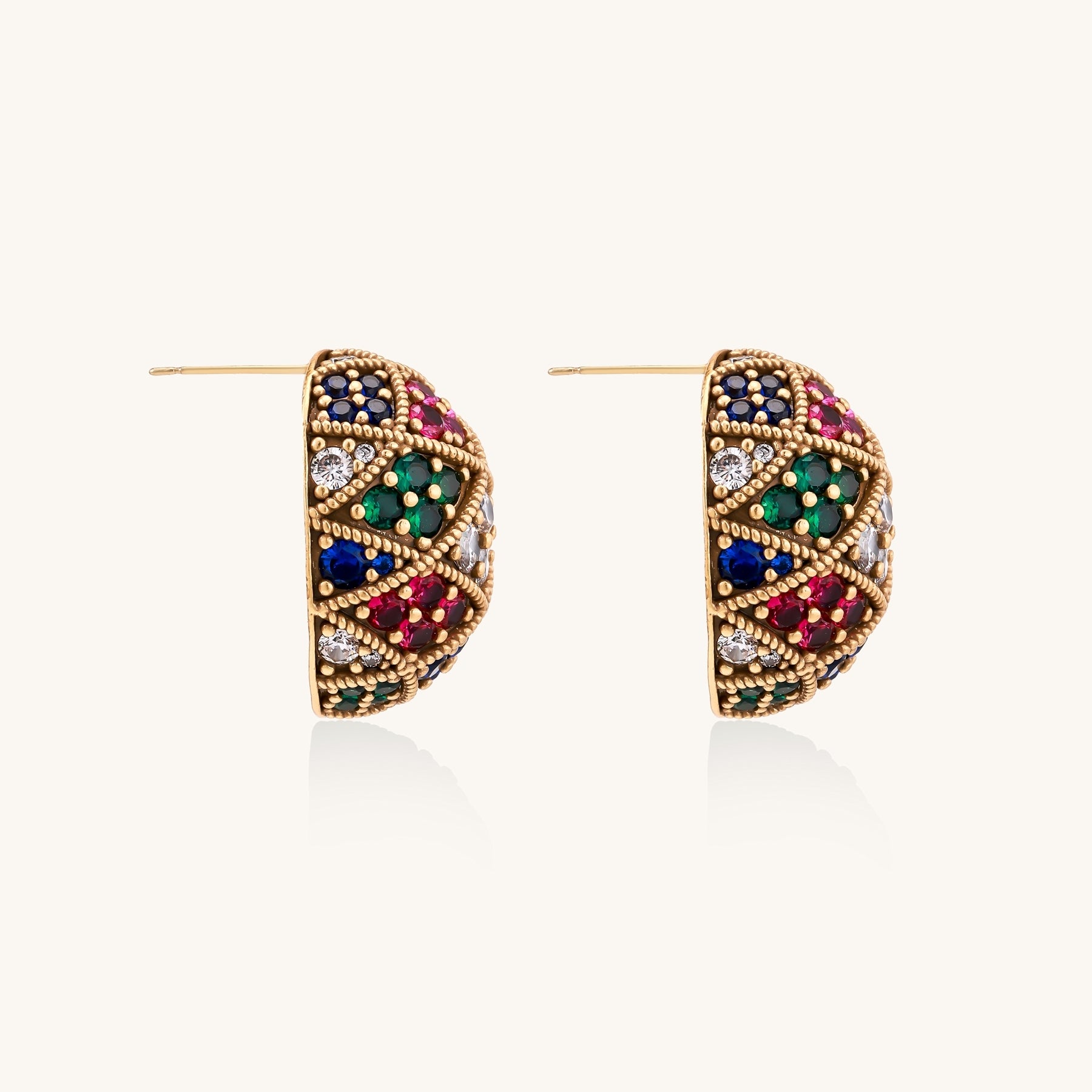 Oval gold-plated stud earrings with multicolor zirconia stones in geometric diamond pattern on white background.