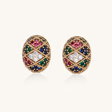 Oval gold-plated stud earrings with multicolor zirconia stones in geometric diamond pattern on white background.