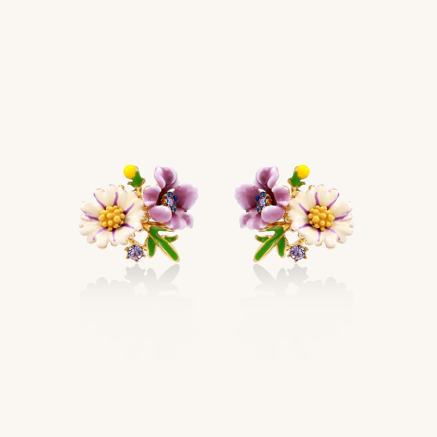 Delicate gold-plated stud earrings featuring white daisy and purple flowers with green leaves and crystal accents