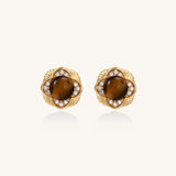 Ornate gold-plated brass stud earrings featuring round tiger's eye stones surrounded by sparkling zirconia in floral design