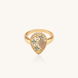 Gold-plated heart ring with turquoise enamel scrollwork and cubic zirconia stones on white background