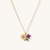 Delicate 18K gold plated necklace featuring colorful enamel flowers in pink and white with green leaves on chain
