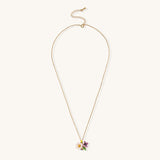 Delicate 18K gold plated necklace featuring colorful enamel flowers in pink and white with green leaves on chain