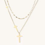 Two layered 14K gold-plated cross necklaces with adjustable chains on light background.
