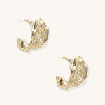 Close-up of gold-plated brass hoop earrings with geometric lattice pattern and sparkling zirconia stones