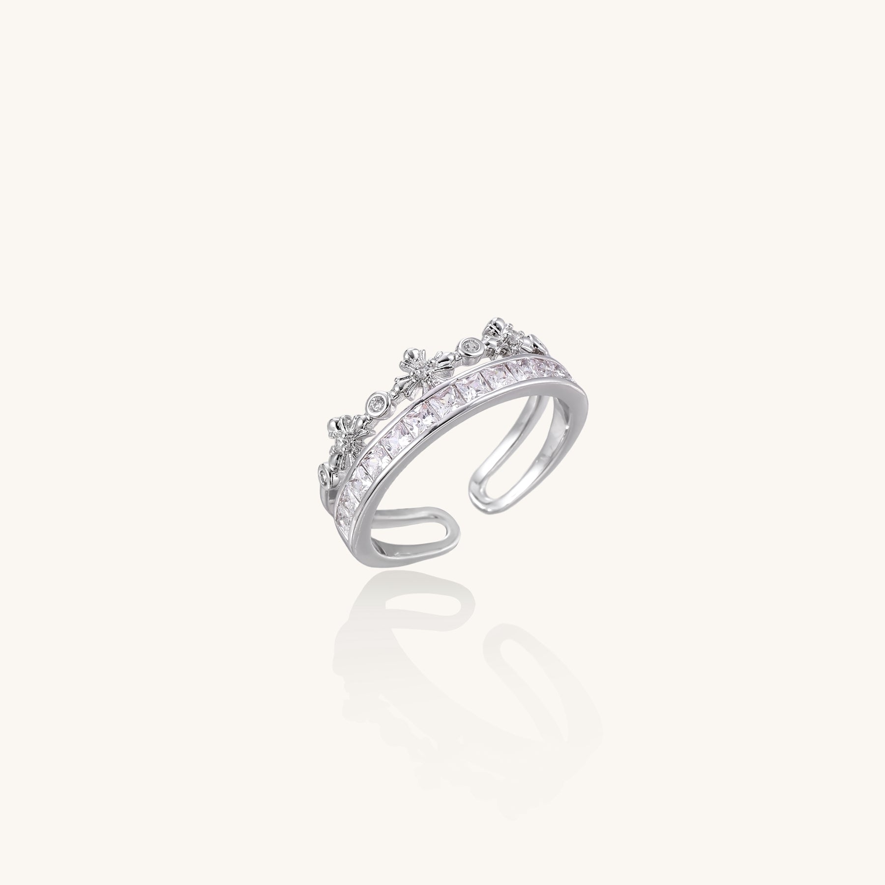 Adjustable gold-plated crown ring with zirconia crystals in ornate tiara design on white background.