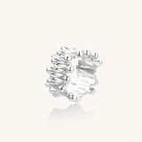 Close-up of an artistic gold-plated brass ring with multiple twisted bands creating a sculptural flowing design