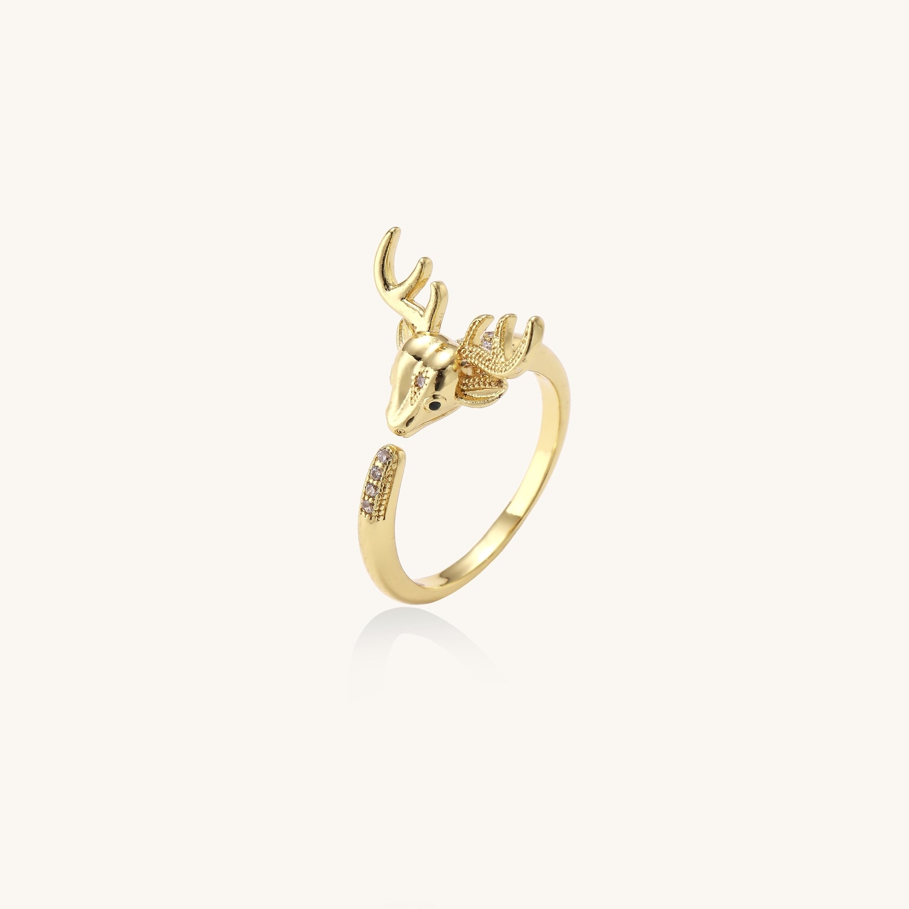 Gold-plated brass deer antler ring with cubic zirconia stones featuring detailed stag head design on white background.
