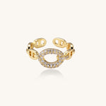 Gold-plated brass chain-link ring with cubic zirconia oval centerpiece, showing adjustable open-back design.