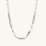 Gold-plated chain necklace with green prasem quartz, freshwater pearls, and mixed beads in modern asymmetrical design