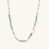 Gold-plated chain necklace with green prasem quartz, freshwater pearls, and mixed beads in modern asymmetrical design