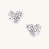 Gold-plated brass stud earrings with intricate twisted knot design and sparkling zirconia stones on neutral background.