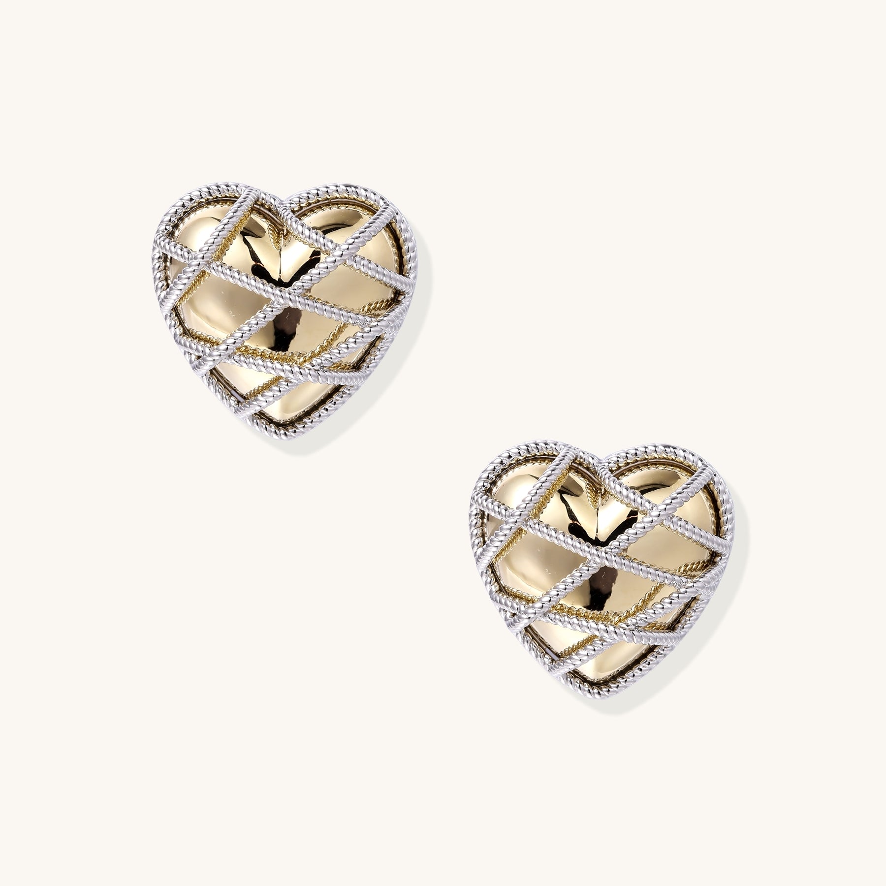 Heart-shaped gold plated earrings with silver rope lattice design and intricate open knotwork pattern
