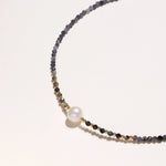 Dainty necklace with faceted purple iolite beads, gold vermeil accents, and central pink-white freshwater pearl.