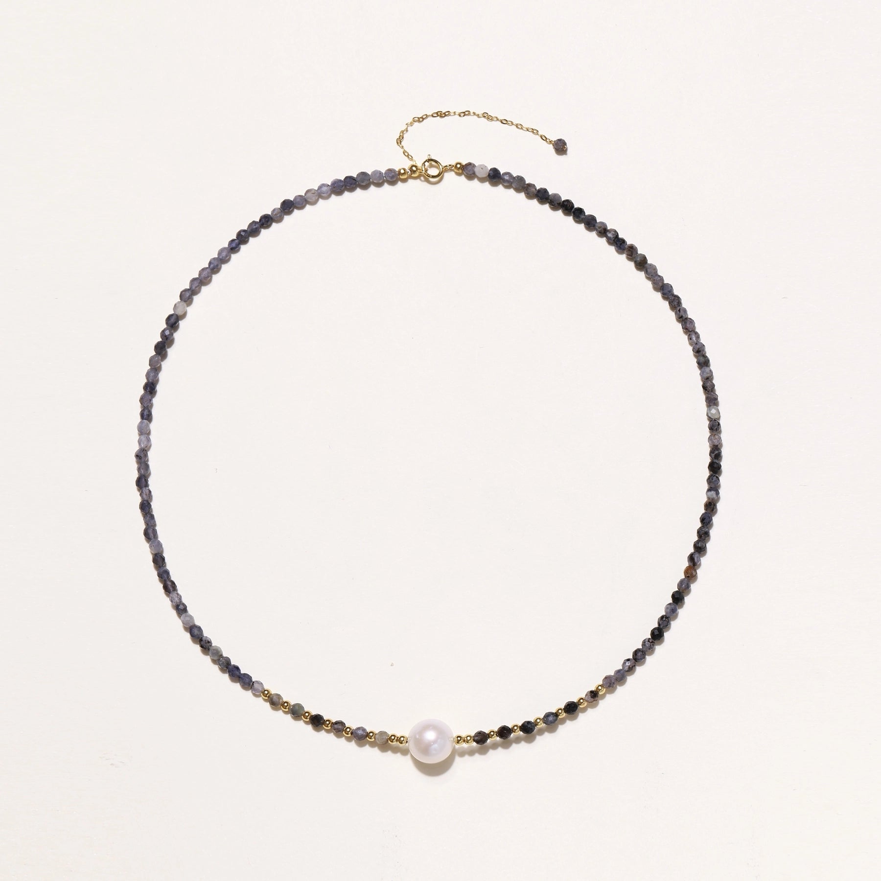 Dainty necklace with faceted purple iolite beads, gold vermeil accents, and central pink-white freshwater pearl.