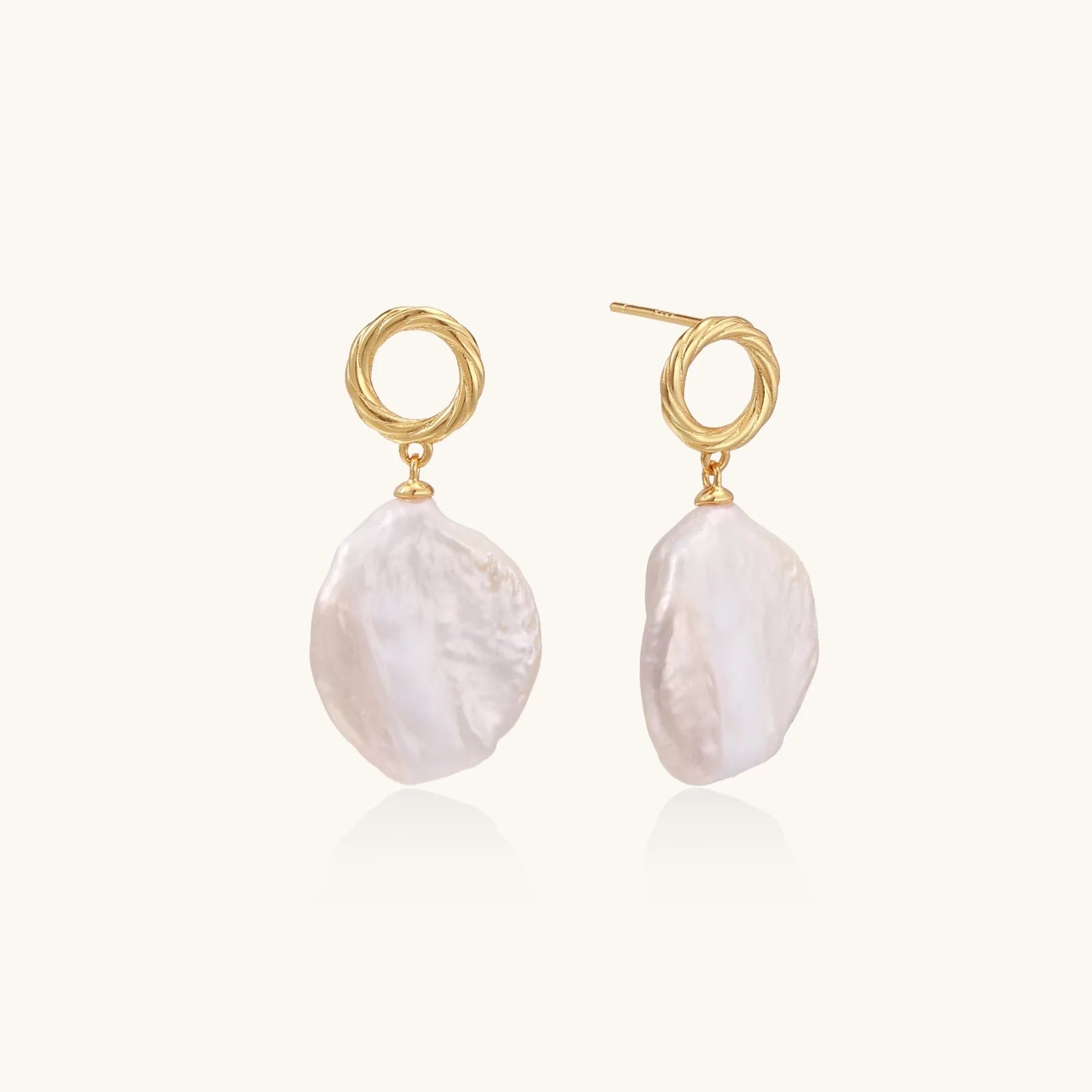 18K gold vermeil twisted circle studs with organic white baroque pearl drops on cream background