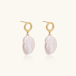18K gold vermeil twisted circle studs with organic white baroque pearl drops on cream background