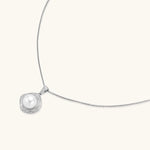 Cushion-shaped double halo pendant with 10mm freshwater pearl center on rhodium-plated sterling silver chain