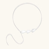 Minimalist sterling silver necklace with three brushed leaf-shaped pendants on delicate chain against white background