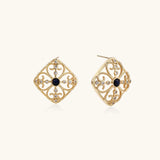 Gold filigree stud earrings with navy lapis lazuli center stone and mother-of-pearl accents in ornate quatrefoil design