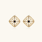 Gold filigree stud earrings with navy lapis lazuli center stone and mother-of-pearl accents in ornate quatrefoil design