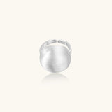 Minimalist brushed sterling silver dome ring with adjustable band on white background, front view.