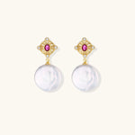 Gold baroque pearl earrings with pink gemstone studs and ornate detailing on cream background.
