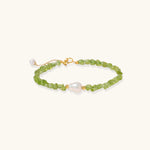Delicate sterling silver bracelet with lime-green peridot gemstone chips and single freshwater pearl centerpiece