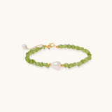 Delicate sterling silver bracelet with lime-green peridot gemstone chips and single freshwater pearl centerpiece