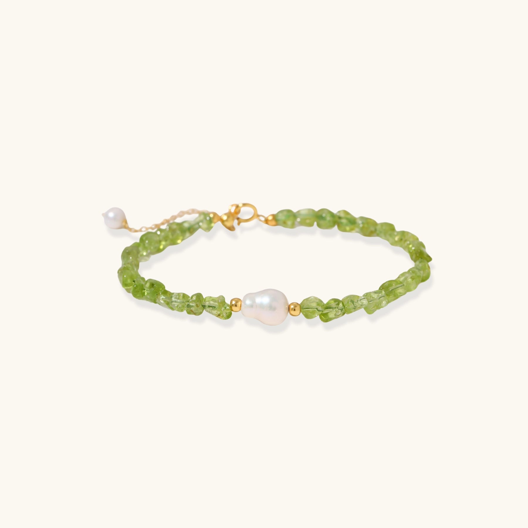 Delicate sterling silver bracelet with lime-green peridot gemstone chips and single freshwater pearl centerpiece